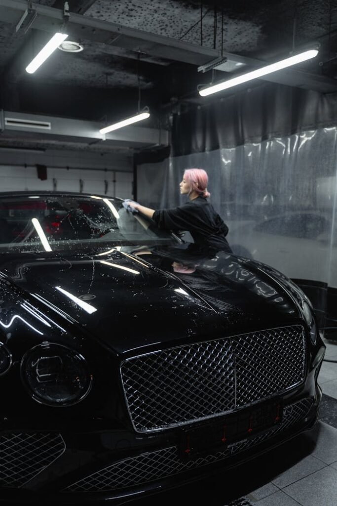 A Woman with Dyed Hair Wiping a Car